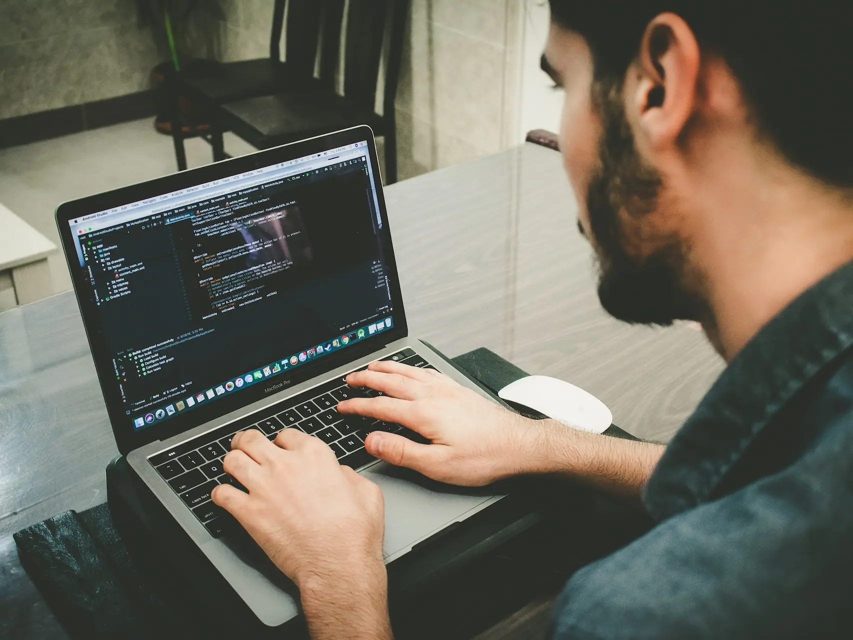 man programming using laptop